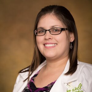Headshot of Angela Bray, pharmacist for the Center for Living Well - Celebration, wearing a white lab coat and glasses