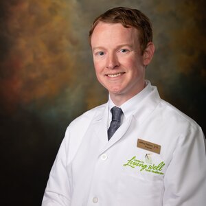 Headshot of Dr. Jeffrey Nelson, board-certified family medicine and osteopathic manipulative medicine provider at the Center for Living Well - Epcot, wearing a white lab coat