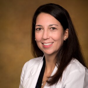 Headshot of Katie Jadra, a female healthcare provider wearing a white lab coat