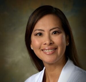 Headshot of Kim Ong, pharmacist at the Center for Living Well - Epcot, wearing a white lab coat