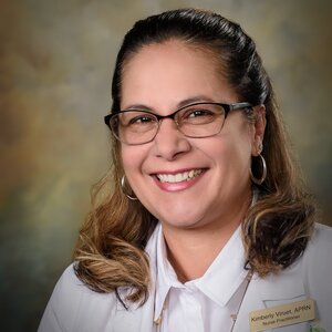 Headshot of Kimberly Viruet, certified Nurse Practitioner for the Center for Living Well - Celebration, wearing a white lab coat