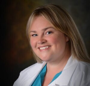 Headshot of Lisa Martin, a female healthcare provider wearing a white lab coat