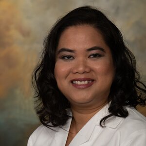 Headshot of Mary Jane Concengco, a board-certified Nurse Practitioner for the Center for Living Well - Celebration, wearing a white lab coat