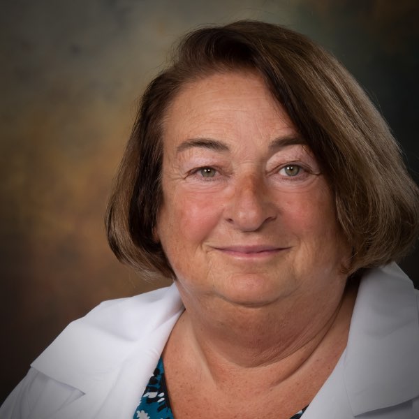 Headshot of Claudia Lesser, Registered Nurse for the Center for Living Well - Celebration, wearing a white lab coat