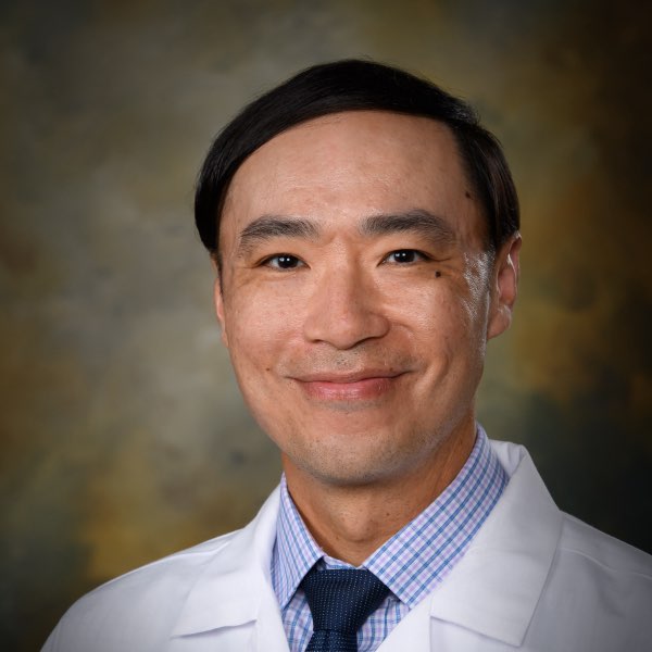 Headshot of David Nguyen, pharmacist at the Center for Living Well - Celebration, wearing a white lab coat