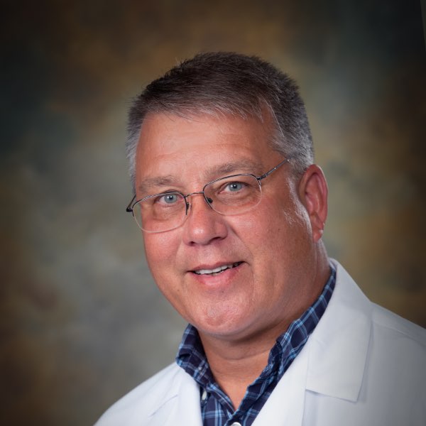 Headshot of Dr. Steven L. Clark, board-certified Family Physician at the Center for Living Well - Celebration, wearing a white lab coat